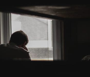 Mourining man in dark room